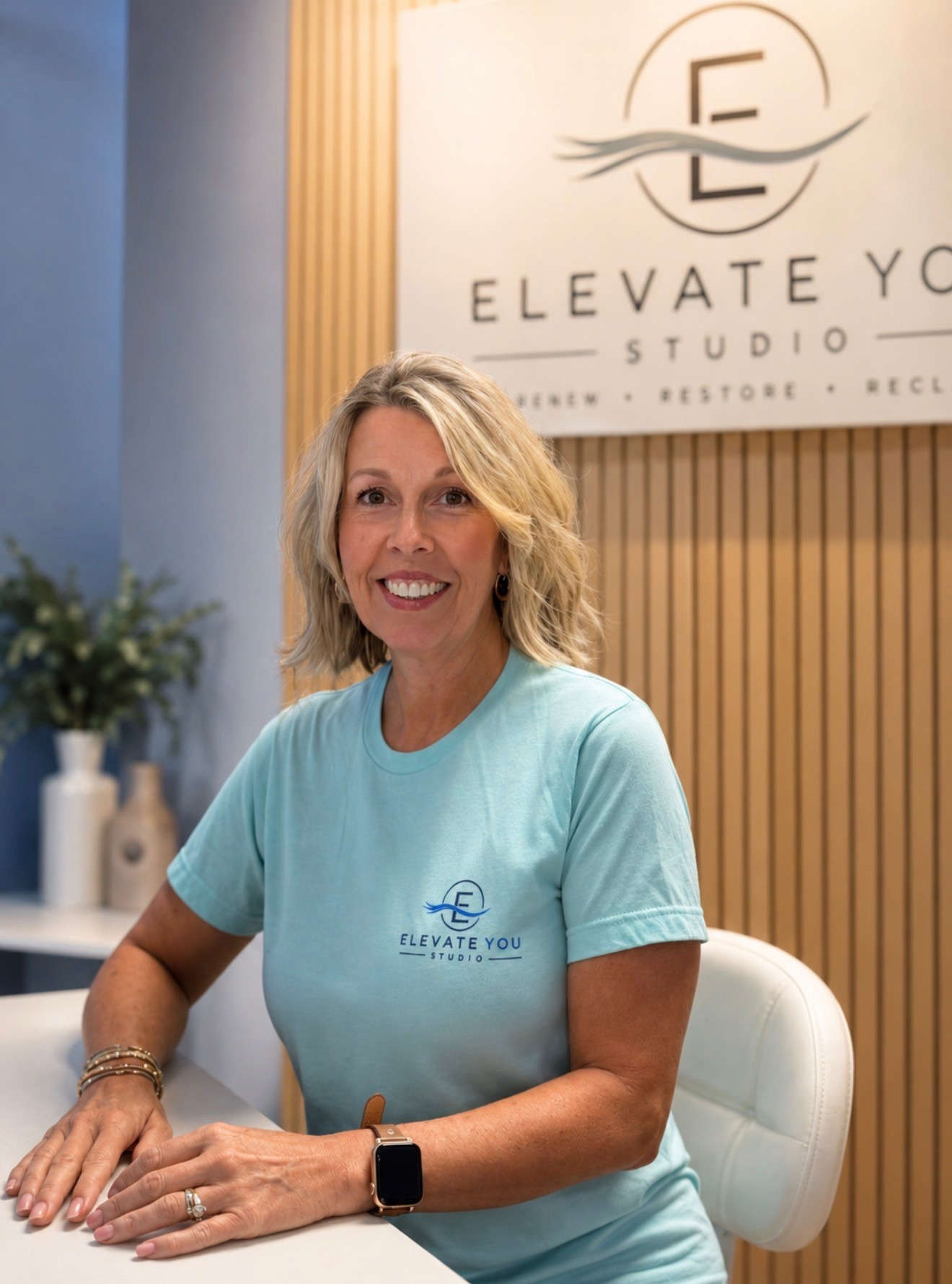 Tammy Duff, owner of Elevate You Studio, seated inside the Glasgow studio